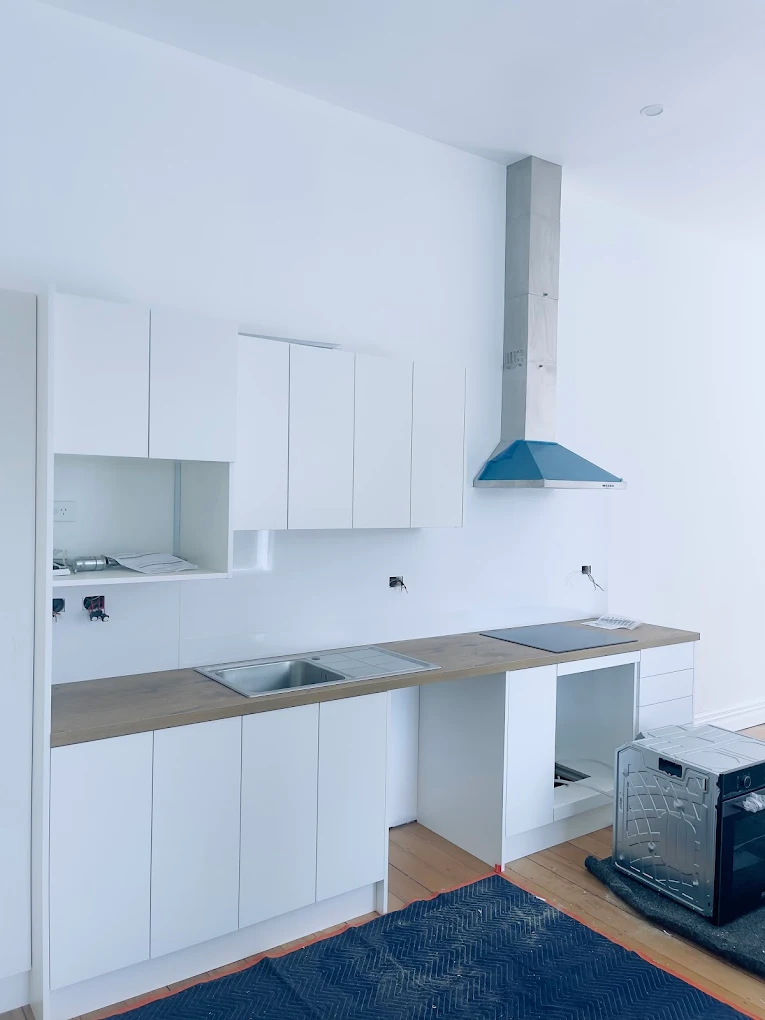 Modern white kitchen renovation with timber benchtop